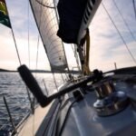 a sailing yacht in Thailand on a yacht delivery heading into the sun with flat water