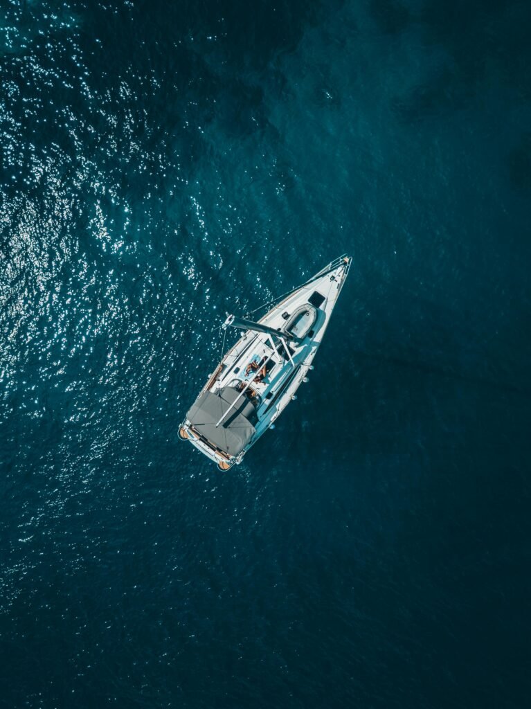 a yacht on a delivery taken from above by a drone with lovely blue water