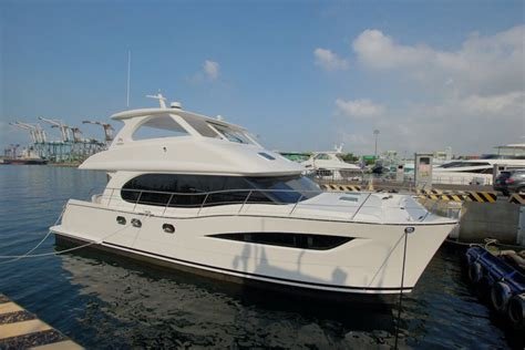 a white Horizon PC52 power catamaran you see the starboard side and black windows