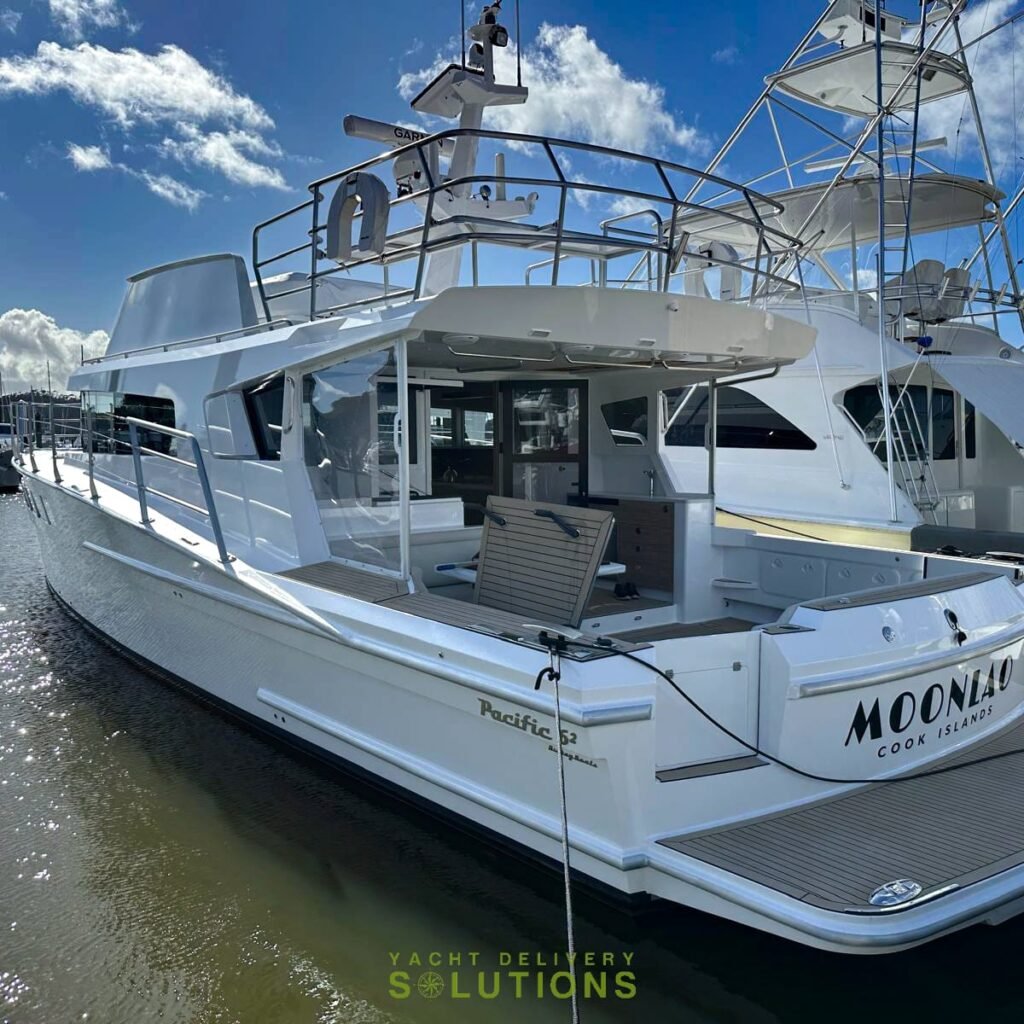 a white Pacific 62 in opua with brown muddy water as its prepared for the yacht delivery solutions Skipper to boars. You can see mainly blue sky with occasional white clouds