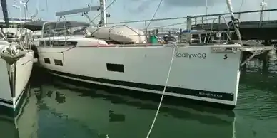white oceanins 50 from the dock showing the starboard bow as the boat is prepared for a yacht delivery