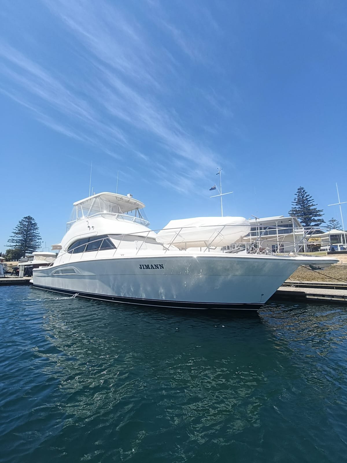 white Riviera motor yacht on the dock after the yacht delivery