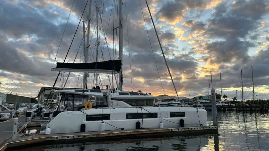 white lagoon 50 on a marina ready for the catamaran delivery skipper with a golden sunset